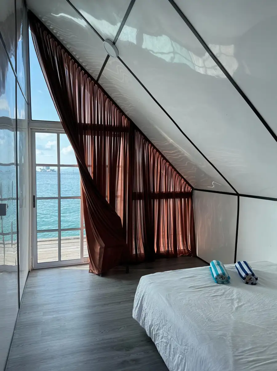 Rustic queen room at Adil Waterhouse Resort featuring a comfortable bed and wooden floor with an A/C unit for a relaxing stay near Pulau Bum Bum.